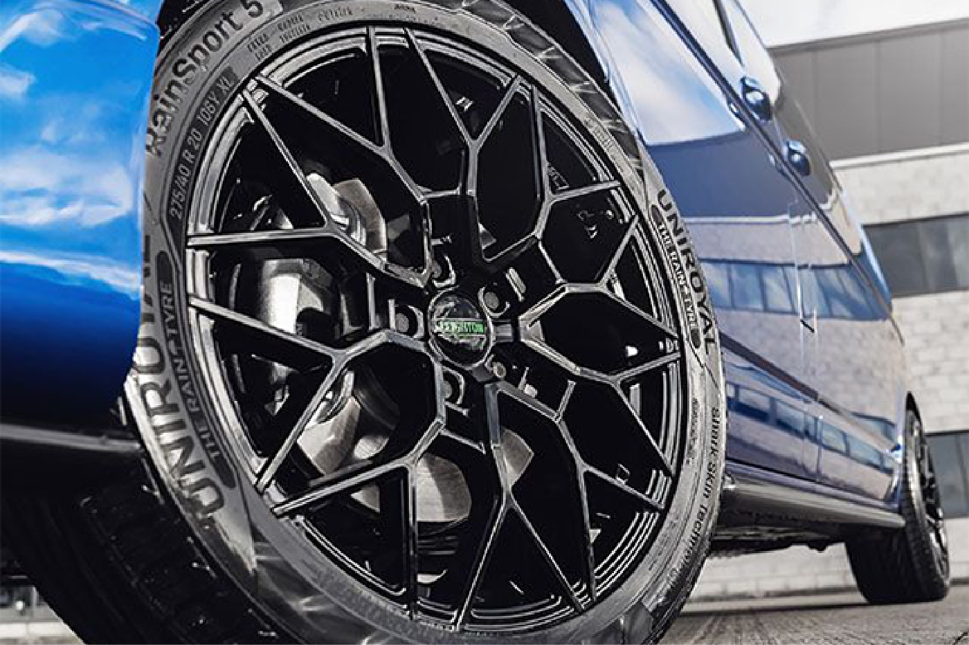 Close-up of premium Leighton Vans alloy wheel on a blue van